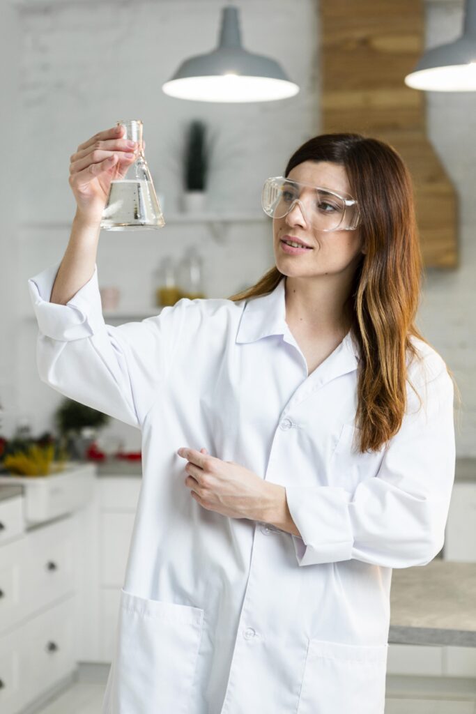 front view female scientist with safety glasses holding test tube lab front view female scientist with safety glasses holding test tube lab